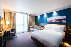 a hotel room with a bed and a desk and a chair at Hampton By Hilton Aberdeen Westhill in Westhill 