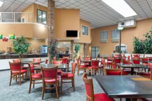 a dining room with tables and red chairs at Quality Inn Alamosa in Alamosa