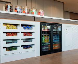 a refrigerator with food and drinks in it at Hampton By Hilton Belfast City Centre in Belfast +57 photos