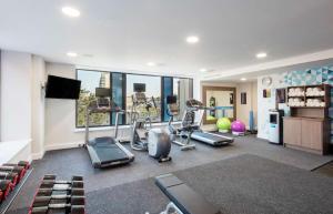 a gym with cardio equipment and a large window at Hampton By Hilton Belfast City Centre in Belfast