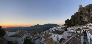 a view of a town with white houses and a mountain at Casa “El Zumaque” en Zahara de la Sierra in Zahara de la Sierra