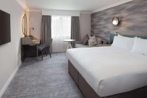 a hotel room with a large bed and a desk at DoubleTree by Hilton Bath in Bath