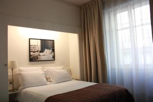 Postel nebo postele na pokoji v ubytování Le Grand Hotel