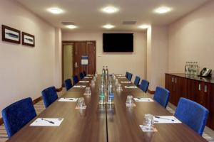 a conference room with a long table and blue chairs at Hampton by Hilton Birmingham Jewellery Quarter in Birmingham