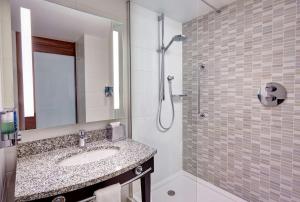 a bathroom with a sink and a shower at Hampton by Hilton Bournemouth in Bournemouth