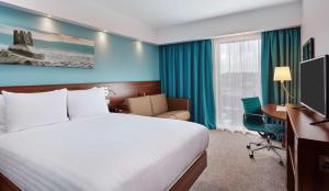 a hotel room with a bed and a desk at Hampton by Hilton Bournemouth in Bournemouth