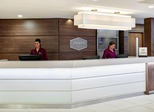 two people sitting at a counter in a dental office at Hampton by Hilton Bristol City Centre in Bristol