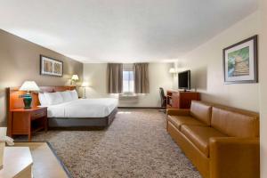 a hotel room with a bed and a couch at Quality Inn & Suites Fillmore I-15 in Fillmore