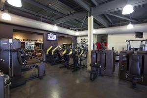 a gym with rows of treadmills and machines at DoubleTree by Hilton Bristol South - Cadbury House in Yatton