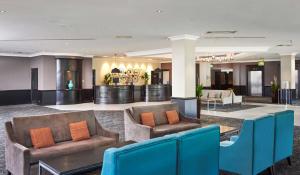 a lobby with couches and chairs in a hotel at DoubleTree by Hilton Coventry in Coventry