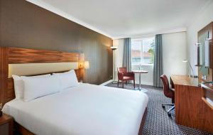 A bed or beds in a room at DoubleTree by Hilton Bristol North