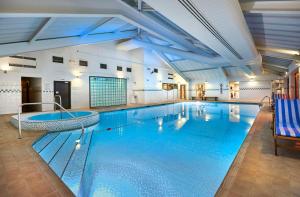 a large swimming pool in a building with a large swimming pool at DoubleTree by Hilton Bristol North in Bristol