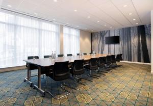 a large conference room with a long table and chairs at Hampton by Hilton Dundee City Centre in Dundee