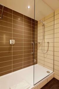 a shower with a glass enclosure in a bathroom at Hilton Garden Inn Doncaster Racecourse in Doncaster