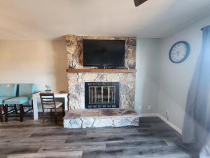 a living room with a fireplace with a flat screen tv at Lakefront condo with a VIEW Osage Beach in Osage Beach