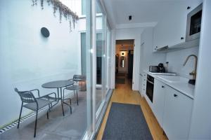 a kitchen with a table and two chairs and a table at Angra Heritage - City Center Hostel in Angra do Heroísmo