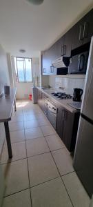 a kitchen with a counter and a table in it at Departamento por Dia en Condominio in Arica