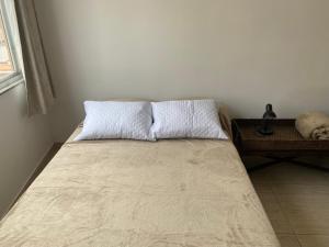 a bed in a room with a pillow on it at M702-Centro in Rio de Janeiro