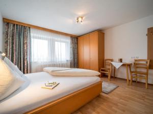 a hotel room with a bed and a table and chairs at Apartment Rohrmoser in Laimach