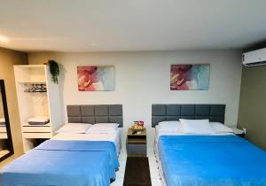 Voodi või voodid majutusasutuse Edifício Creta Hotel toas
