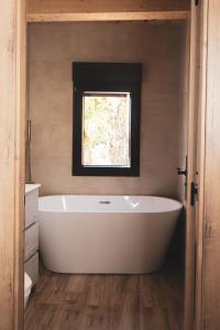 a bath tub in a bathroom with a window at CASA RURAL EL PADRONCILLO in Riópar