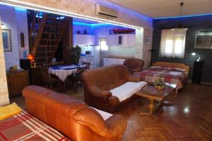 a living room with a couch and a table and a kitchen at Apartments and rooms by the sea Nin, Zadar - 5858 in Nin