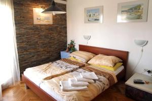 a bedroom with a large bed with towels on it at Apartments and rooms by the sea Nin, Zadar - 5858 in Nin