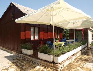 a patio with a table and an umbrella and chairs at Apartments and rooms by the sea Nin, Zadar - 5858 in Nin