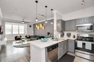a kitchen and living room with stainless steel appliances at Luxury 1BR apt ,NRG ,Downtown ,Med Center,Galleria in Houston