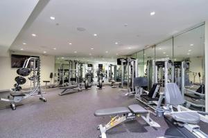 a gym with several tread machines and mirrors at Luxury 1BR apt ,NRG ,Downtown ,Med Center,Galleria in Houston