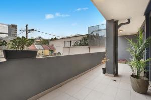 an apartment balcony with a view of a city at Urban Retreat in Surry Hills l 2 Bedroom Property with Parking in Sydney