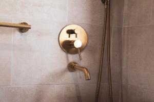 a shower in a bathroom with a brass shower head at CASA RURAL EL PADRONCILLO in Riópar