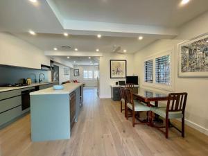 a kitchen and dining room with a table and chairs at DRUM8- 3 Bed townhouse Drummoyne in Sydney