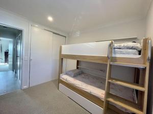 a room with two bunk beds and a hallway at DRUM8- 3 Bed townhouse Drummoyne in Sydney