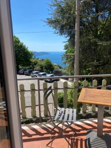 una mesa y sillas en un balcón con vistas a la calle en Ca' ai Tigli, en Tignale