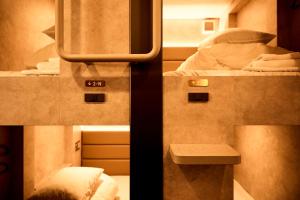 two pictures of a room with two beds in a train at Book Tea Bed SHIBUYA in Tokyo