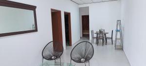 a living room with two chairs and a table at ADIMA Homestay in Kuala Terengganu