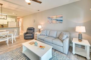 a living room with a couch and a table at Serene Myrtle Beach Condo with Community Pool! in Myrtle Beach
