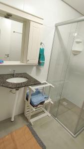 a bathroom with a sink and a shower at Apto em Santo Ângelo in Santo Ângelo