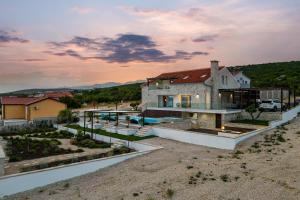 a house with a swimming pool in the desert at Family friendly house with a swimming pool Maslenica, Novigrad - 20492 in Maslenica