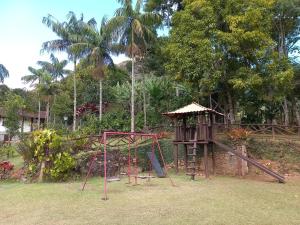 a playground in a park with a swing set at Casa com churrasqueira piscina privativa em São Pedro da Serra - Perto de Lumiar in Nova Friburgo