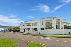 a white building on the side of a road at Waimahana Apartment 8 in Taupo