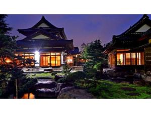 a building with a garden in front of it at night at Aizuwakamatsu - House - Vacation STAY 94546v in Aizuwakamatsu +10 photos