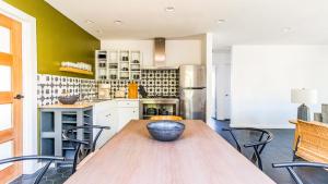 a kitchen with a wooden table and chairs at Contemporary Front House with Shared Patio in Long Beach