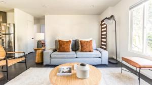 a living room with a couch and a table at Contemporary Front House with Shared Patio in Long Beach