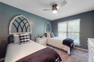 a bedroom with two beds and a window at Seven Rings in Dauphin Island