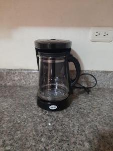 a black coffee maker sitting on a counter at Andaluz Townhouse for Rent in Loja