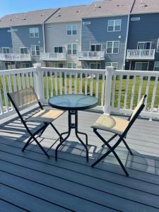 a patio table and two chairs on a deck at Ruby Home in Bowie