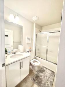 a bathroom with a toilet and a sink and a shower at Ruby Home in Bowie