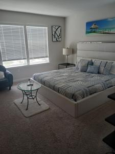 a bedroom with a large bed and a table at Ruby Home in Bowie